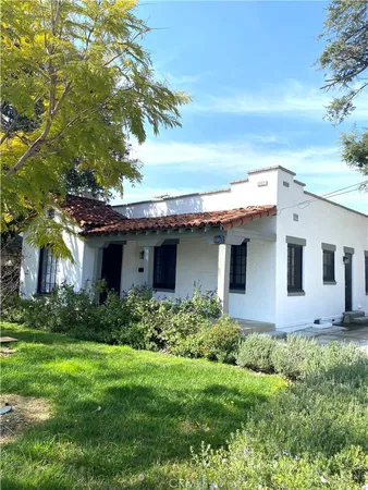 a front view of house with yard and trees