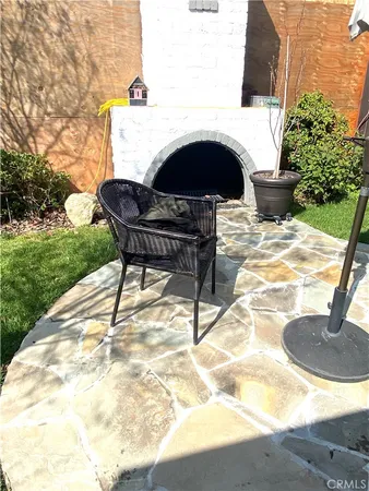 a view of a patio with a table and chairs