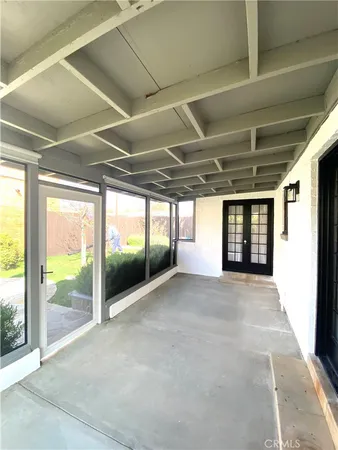 a view of an empty room with a window and brick walls
