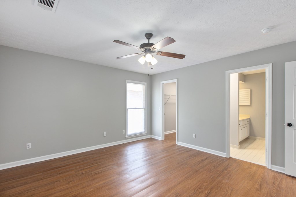 3613 Maryland Circle, Unit A Columbus, GA 31907 - Photo 11 of 28 wooden floor in an empty room with a window