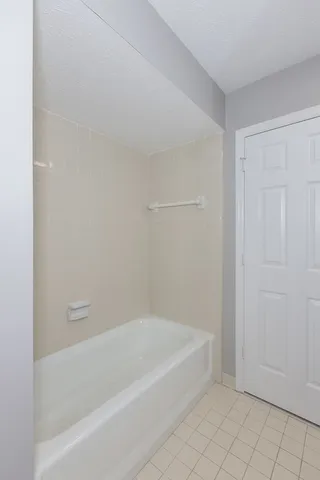 a spacious bathroom with bathtub and shower