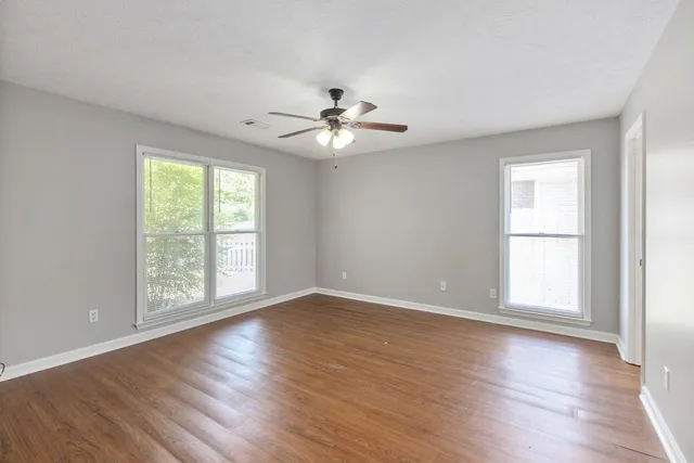 wooden floor in an empty room with a window