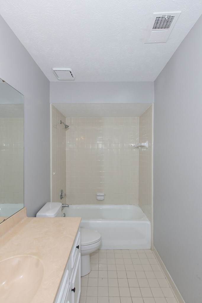 3613 Maryland Circle, Unit A Columbus, GA 31907 - Photo 16 of 28 a bathroom with a granite countertop sink a toilet and shower