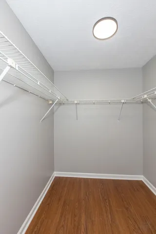 a view of a room with wooden floor