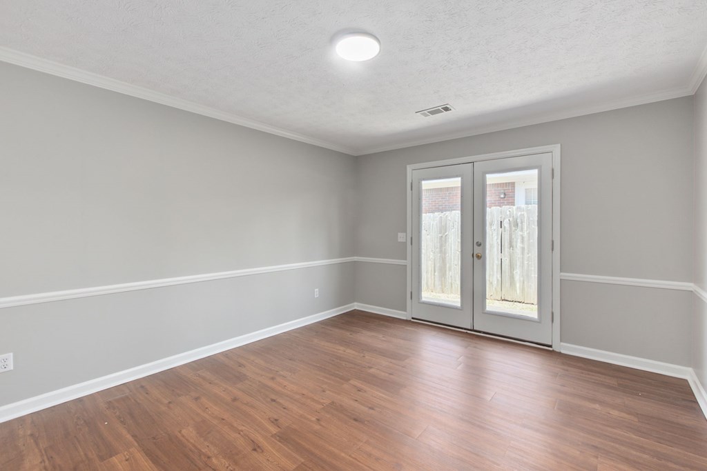 3613 Maryland Circle, Unit A Columbus, GA 31907 - Photo 21 of 28 wooden floor in an empty room with a window