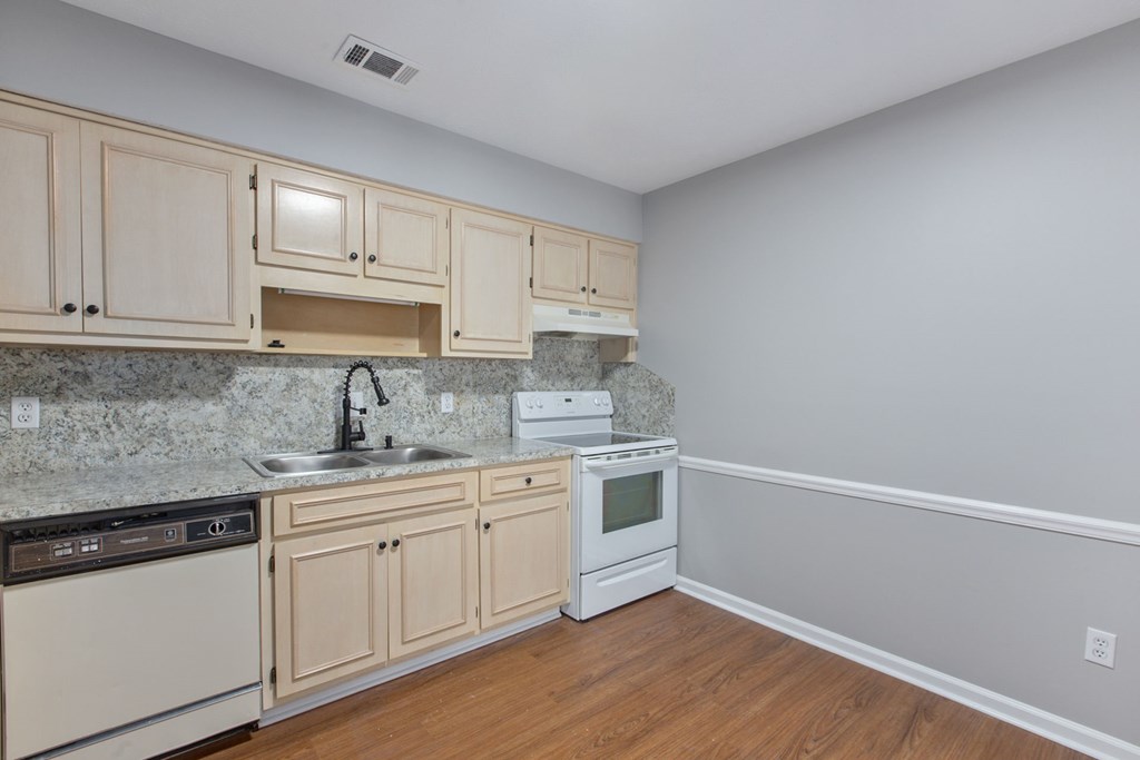 3613 Maryland Circle, Unit A Columbus, GA 31907 - Photo 22 of 28 a kitchen with a sink cabinets and wooden floor