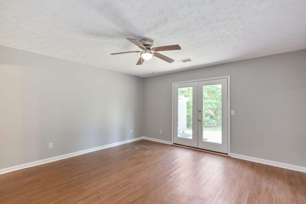 3613 Maryland Circle, Unit A Columbus, GA 31907 - Photo 25 of 28 a view of an empty room with a window and wooden floor