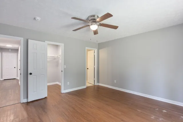 wooden floor in an empty room with a window