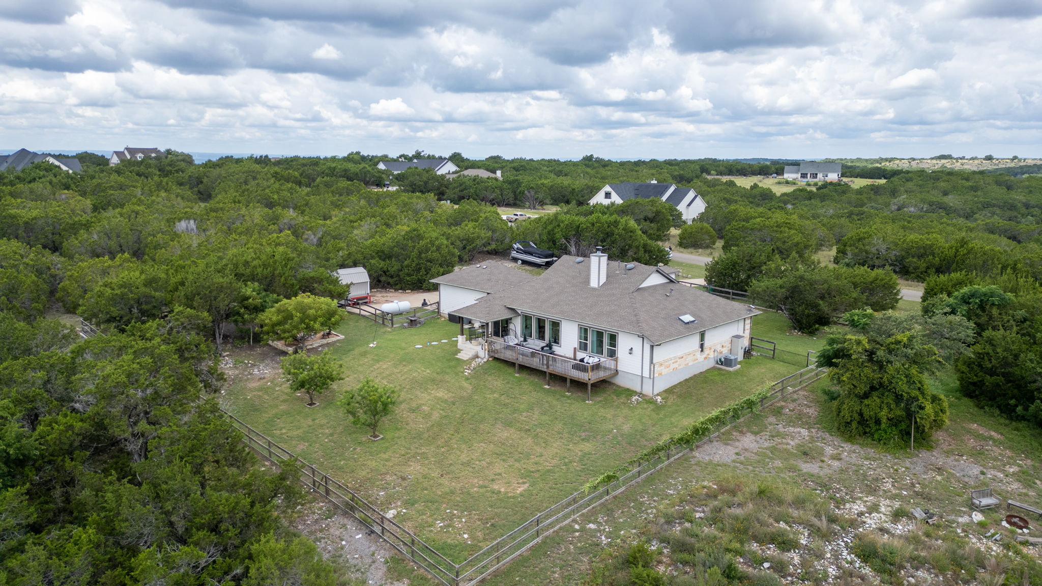 155 Balcones Ridge Way Bertram, TX 78605 - Photo 2 of 37 An aerial perspective reveals the charming home nestled within trees and long distant vistas.