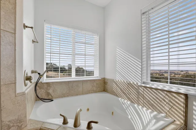 a bathroom with a tub and a window