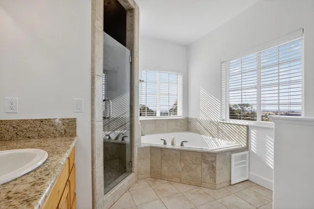 a bathroom with bathtub and window