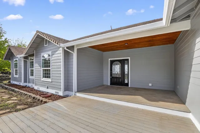 a view of a house with a wooden deck