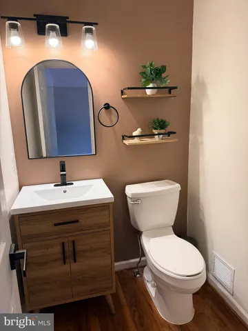a bathroom with a toilet sink and mirror