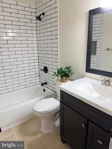 a bathroom with a sink mirror toilet and bathtub