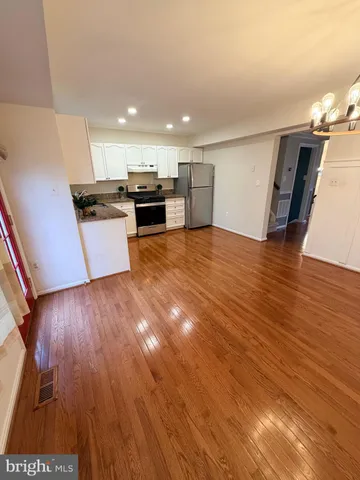 a view of kitchen with cabinets and wooden floor