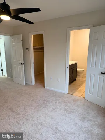 a bathroom with a double vanity sink mirror and toilet