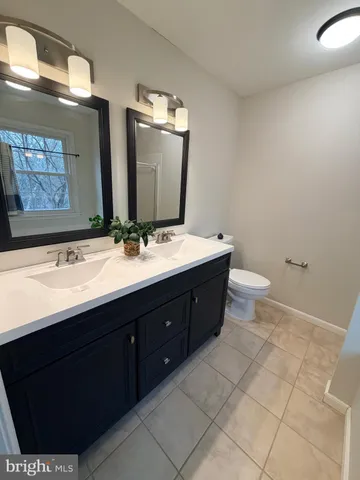 a bathroom with a sink and a mirror with toilet