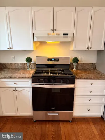 a stove top oven sitting inside of a kitchen