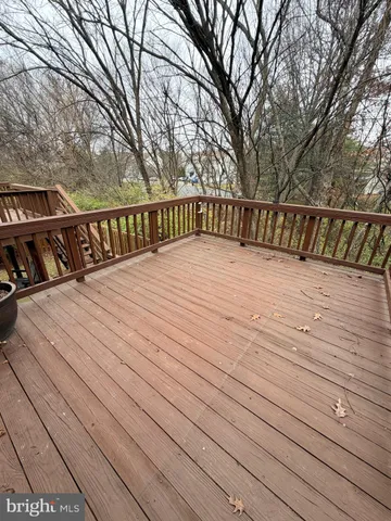 a view of balcony with wooden floor and fence