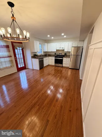 a view of kitchen with cabinets and wooden floor