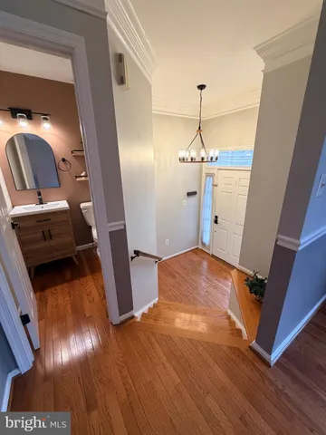 a view of a livingroom with wooden floor and staircase