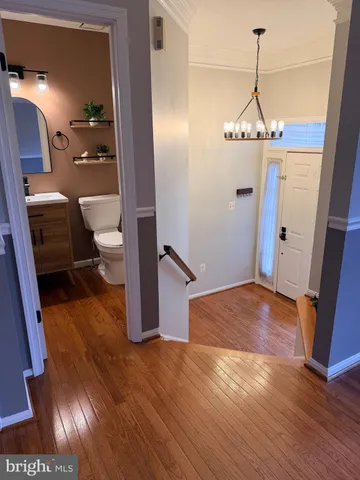 a view of a room with wooden floor and staircase