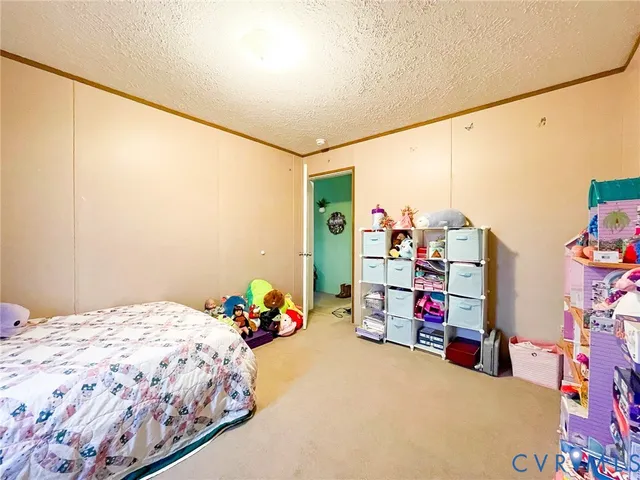 a bedroom with a bed a desk and many windows