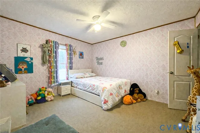 a bedroom with a bed and a ceiling fan