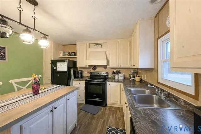 a kitchen with sink a refrigerator and cabinets