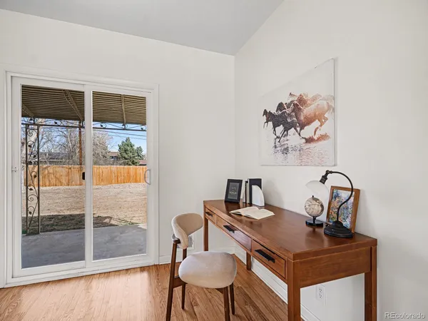 a view of a workspace with furniture and front door