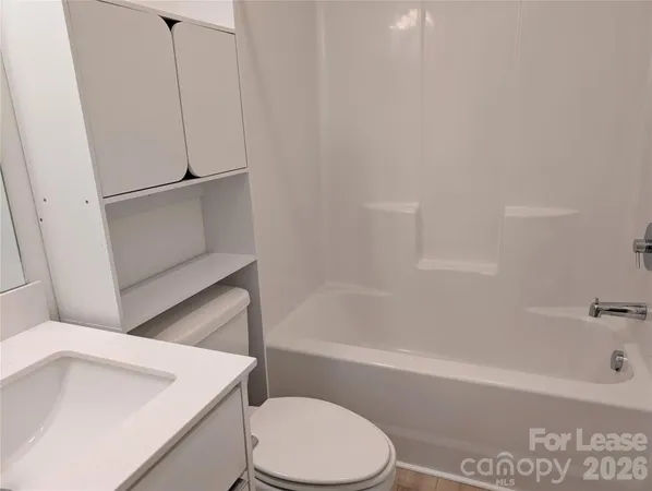 a bathroom with a sink a toilet and bathtub