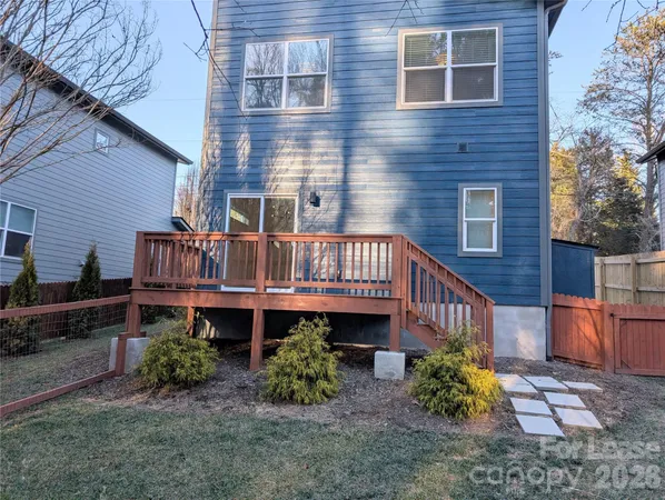a view of a house with brick walls and flower plants