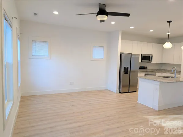 a view of kitchen with refrigerator microwave and stove