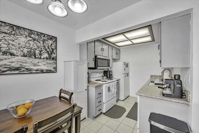 a kitchen with stainless steel appliances furniture stove top oven and cabinets