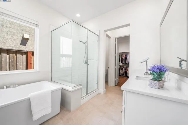 a spacious bathroom with a tub shower and sink