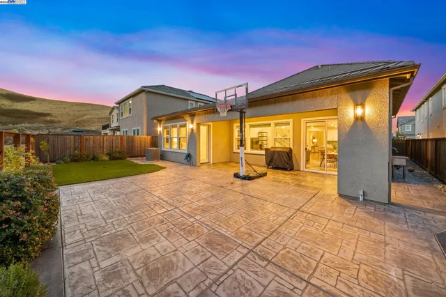 a view of a house with backyard and porch