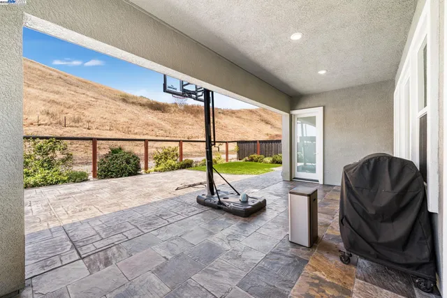 a front view of a house with a yard and potted plants