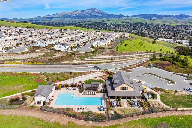 an aerial view of a tennis ground and a city view