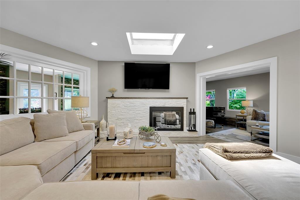 5351 Godfrey Road Parkland, FL 33067 - Photo 15 of 100 a living room with furniture a flat screen tv and a fireplace