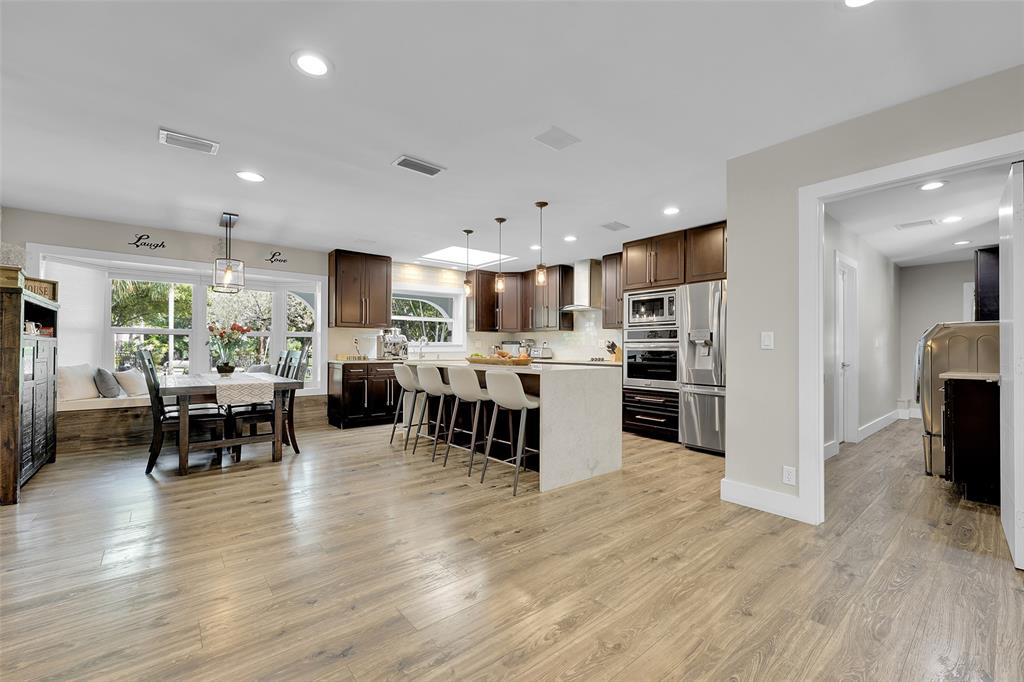5351 Godfrey Road Parkland, FL 33067 - Photo 16 of 100 a kitchen with stainless steel appliances kitchen island granite countertop a refrigerator and cabinets