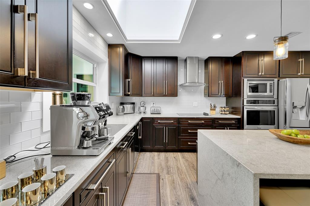 5351 Godfrey Road Parkland, FL 33067 - Photo 21 of 100 a kitchen with stainless steel appliances granite countertop a sink stove and refrigerator