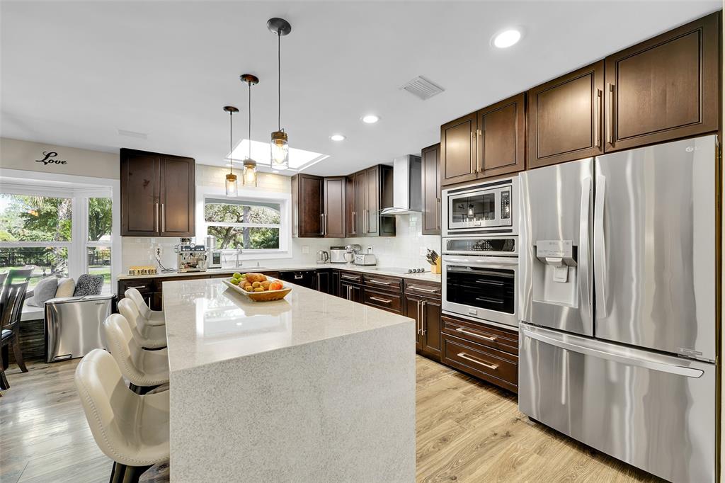 5351 Godfrey Road Parkland, FL 33067 - Photo 23 of 100 a kitchen with stainless steel appliances a refrigerator sink and stove