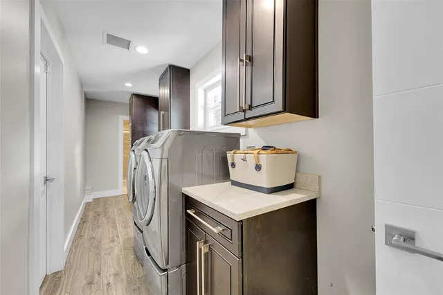 a kitchen with stainless steel appliances a dining table chairs microwave and sink