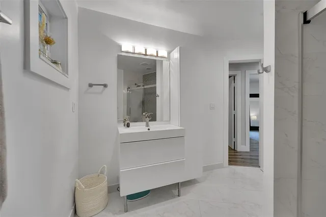 a bathroom with a sink a toilet and shower