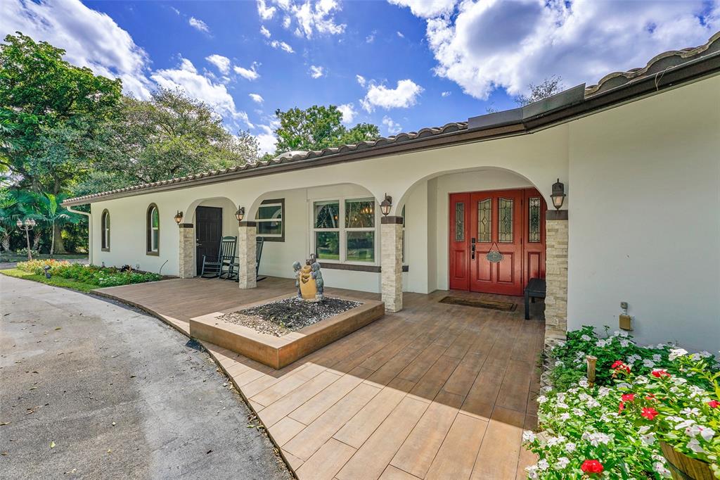 5351 Godfrey Road Parkland, FL 33067 - Photo 4 of 100 a front view of a house with a garden