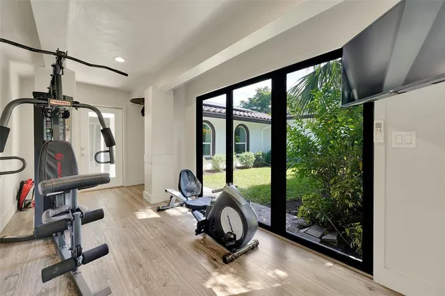 a view of a patio with table and chairs potted plants with wooden floor and fence