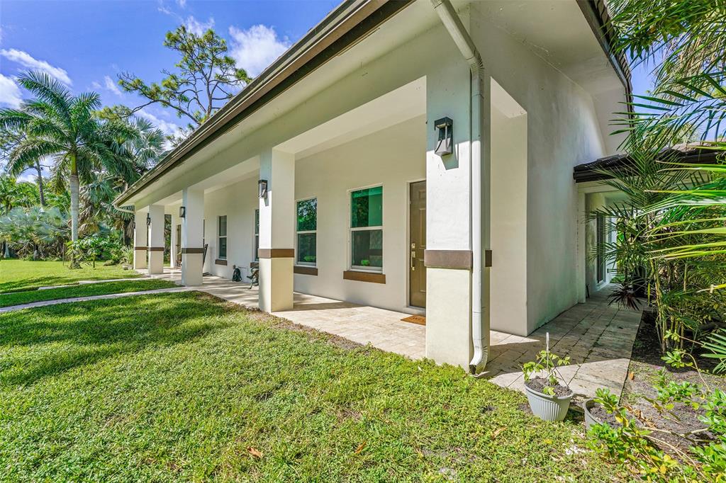 5351 Godfrey Road Parkland, FL 33067 - Photo 49 of 100 a view of a house with backyard and a tree