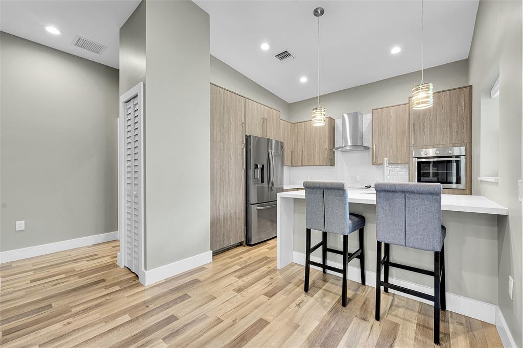 5351 Godfrey Road Parkland, FL 33067 - Photo 53 of 100 a kitchen with stainless steel appliances a dining table chairs microwave and sink