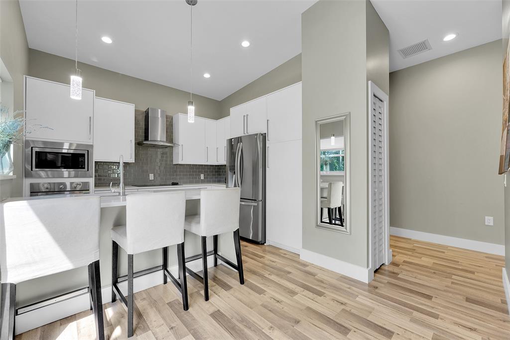 5351 Godfrey Road Parkland, FL 33067 - Photo 63 of 100 a kitchen with stainless steel appliances granite countertop a refrigerator and a stove top oven
