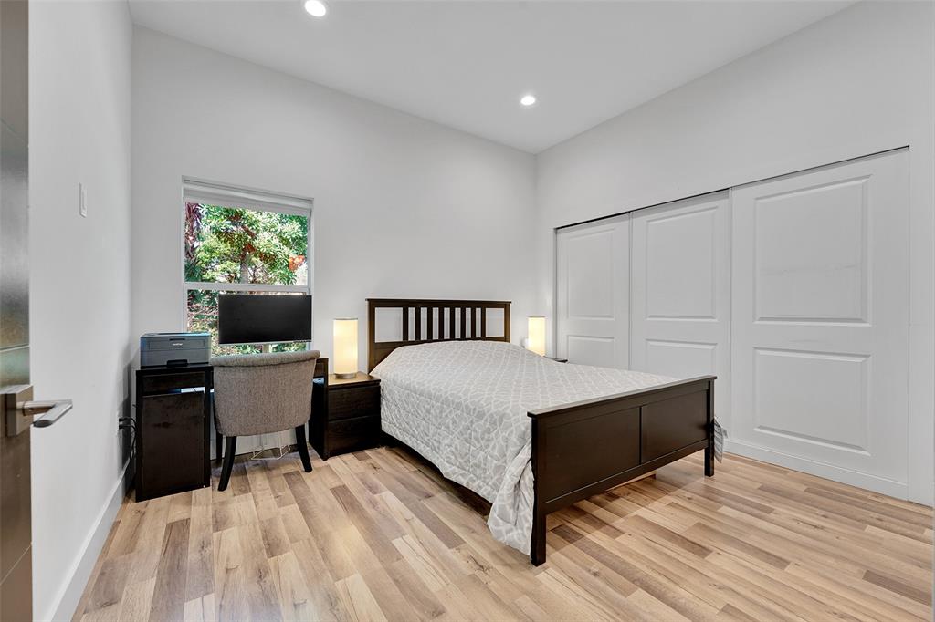5351 Godfrey Road Parkland, FL 33067 - Photo 66 of 100 a bedroom with a bed and a table